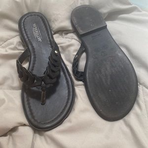 Size 7 black flip flops with braid like top.